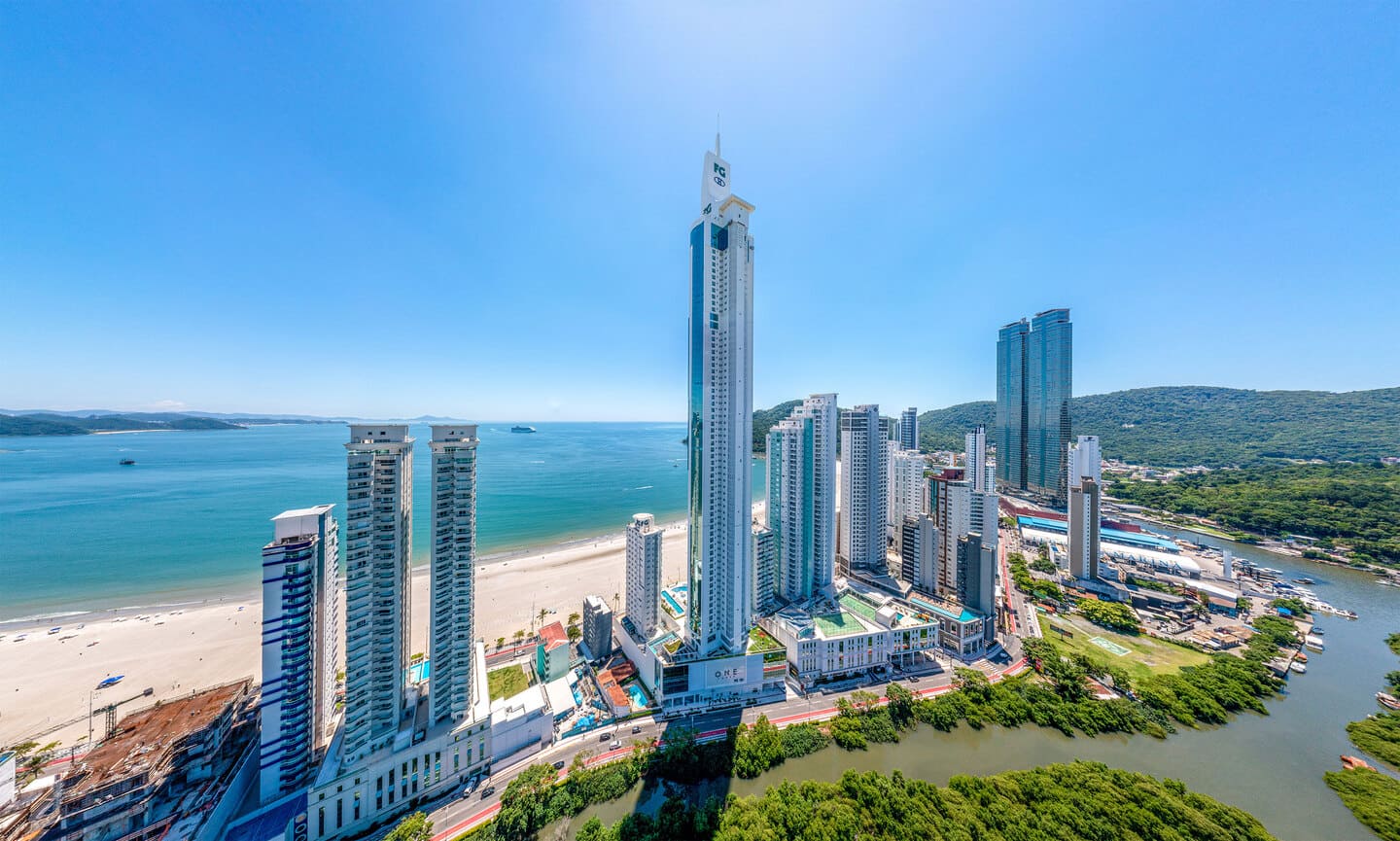 Contemplative aerial view of the geographic narrowing of Barra Sul between the Atlantic Ocean and the mouth of the Camboriú River