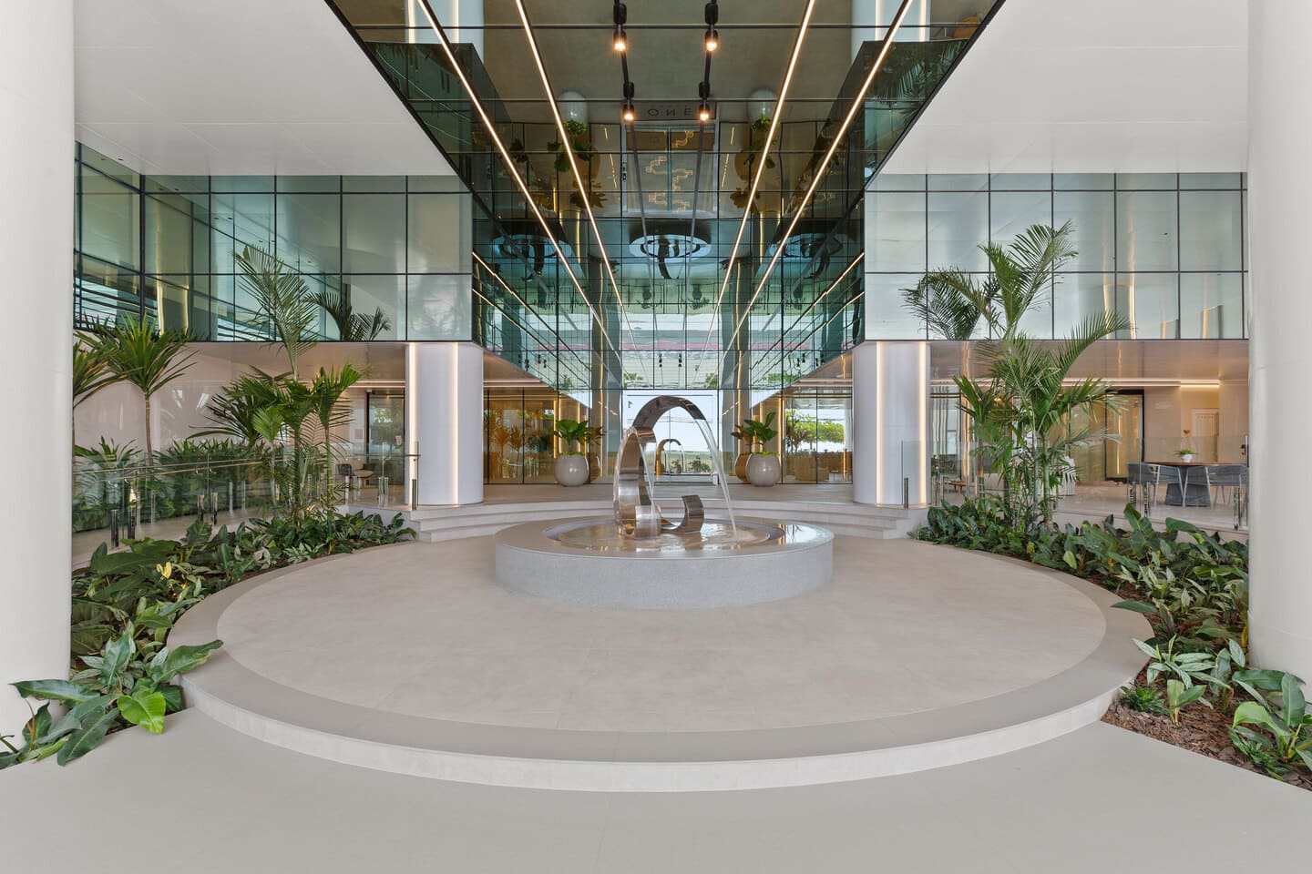 Outdoor contemplation plaza with circular sculptural ring, reflecting pool, and translucent marble walls