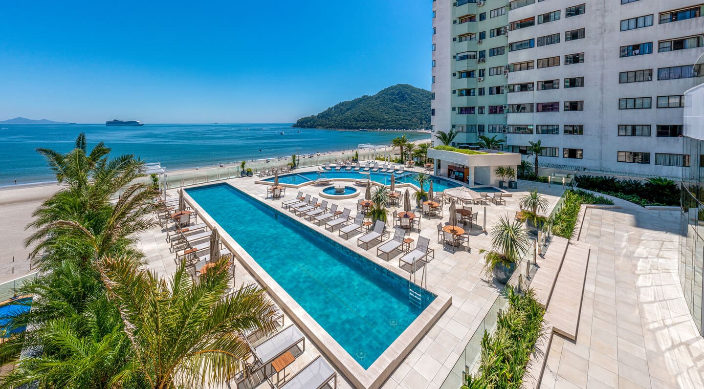 Relaxation sun deck with contemporary loungers and open views toward the beach and maritime horizon